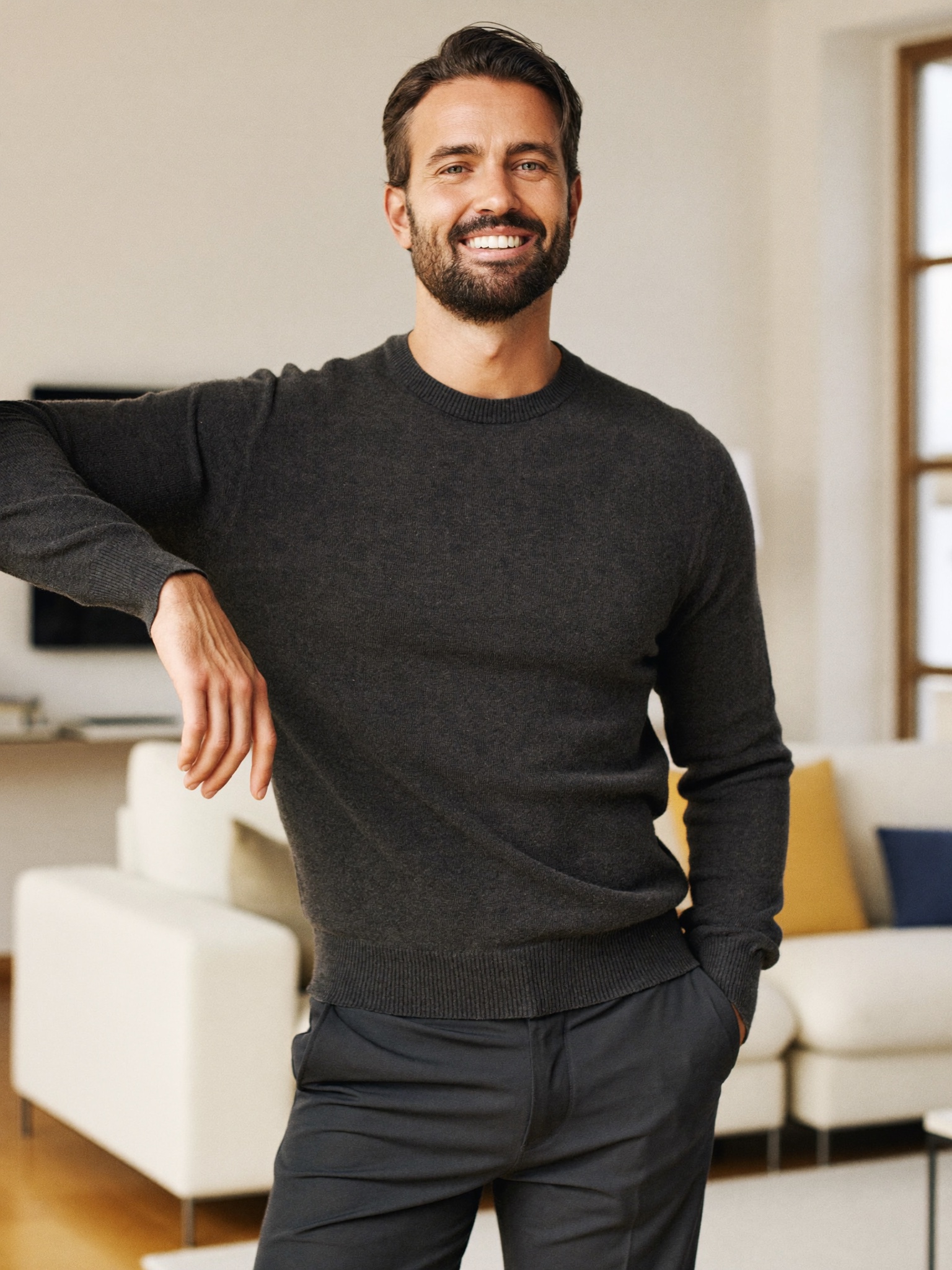 A confident man at ease in a bright modern home, years after finishing his bariatric weight-loss transformation