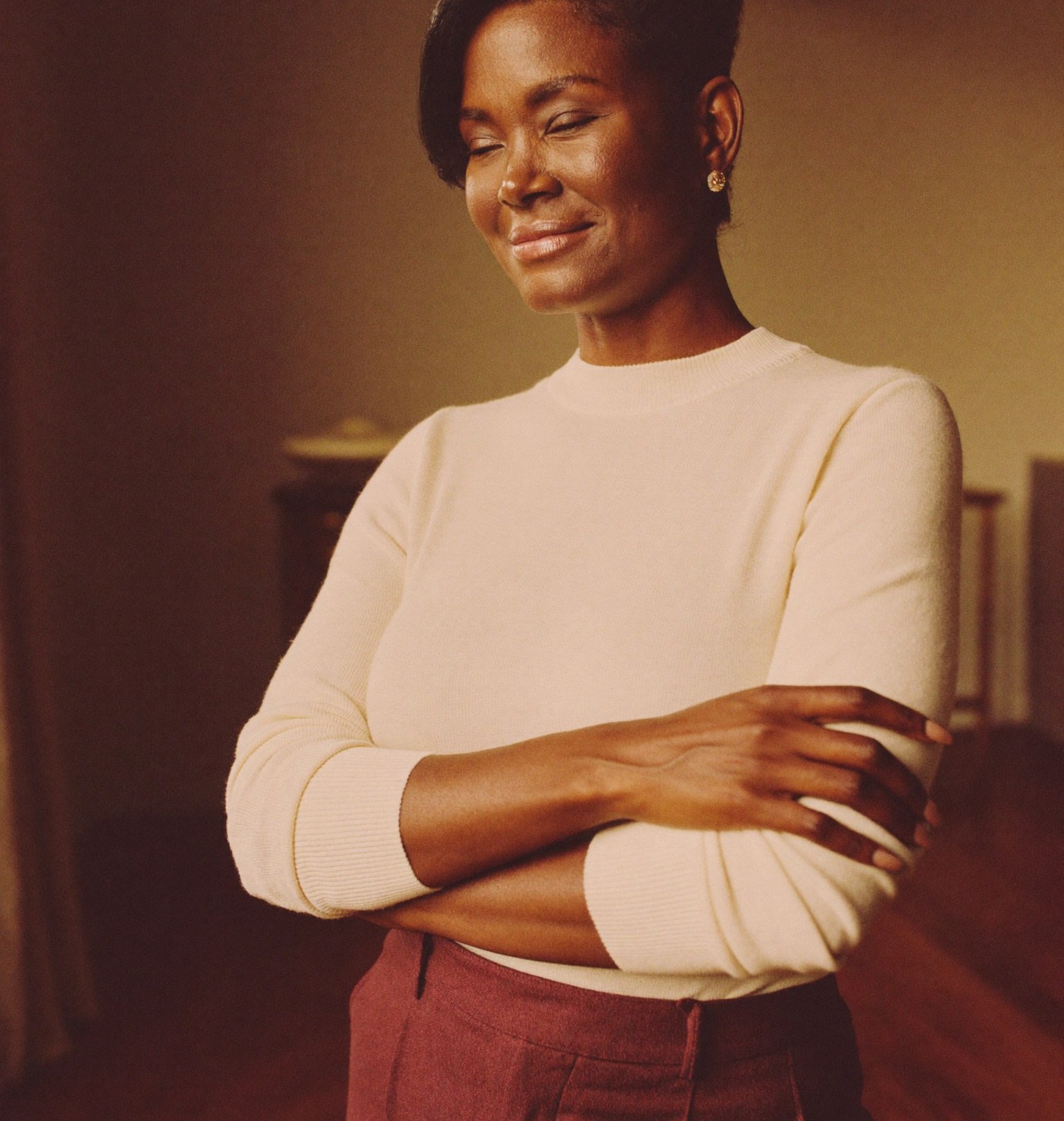 A calm, confident woman in warm natural light, at ease years after finishing her weight-loss journey